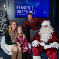 Parents with daughter smile with Santa
